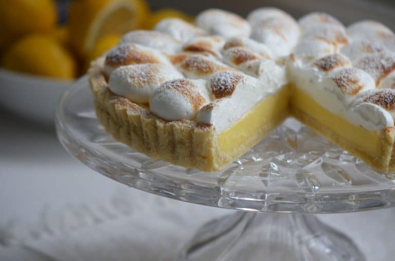Lemon meringue tart on a footed crystal plate
