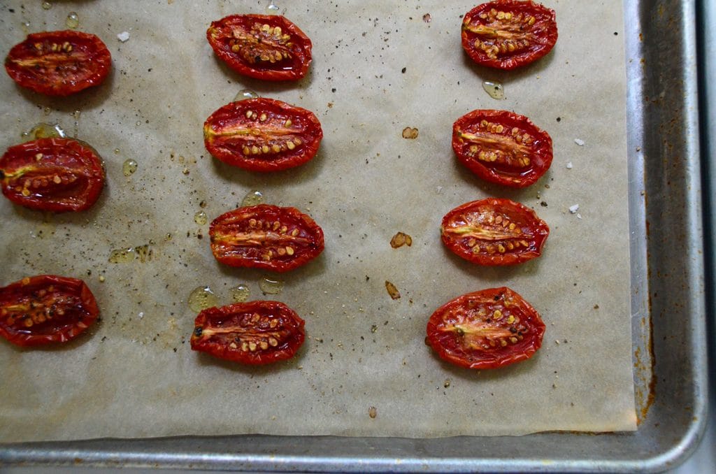 Roasted cherry tomato halves on a parchment lined sheet pan, Maureen Abood