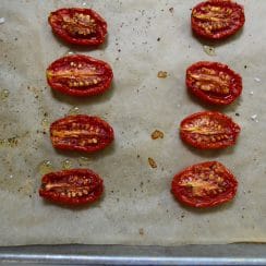 Roasted cherry tomato halves on a parchment lined sheet pan, Maureen Abood
