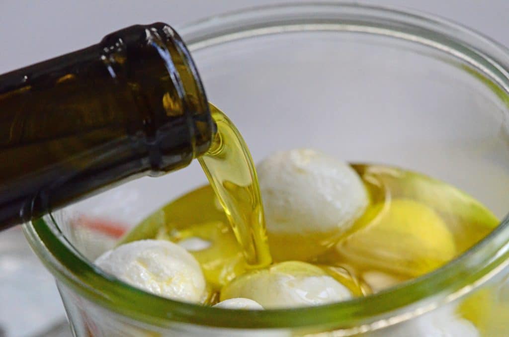 Extra virgin olive oil poured over labneh balls, Maureen Abood