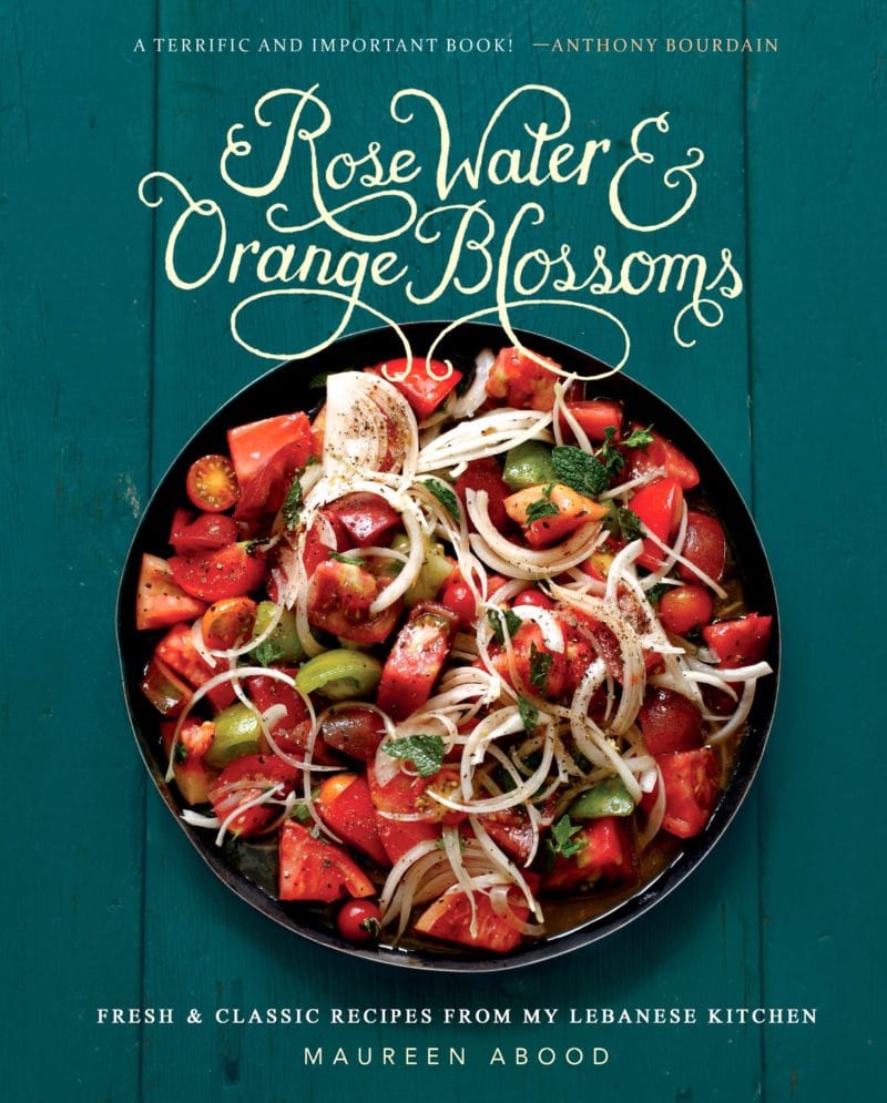 Tomato salad on a green background on the cover of the Rose Water & Orange Blossoms cookbook