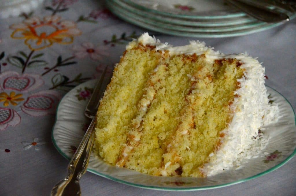 Triple layer coconut cake slice with a fork