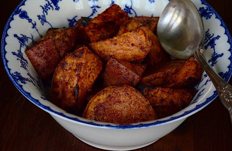 Roasted sweet potatoes with raw honey in a bowl