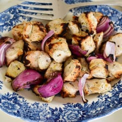 Grilled marinated chicken kebabs on a vintage blue platter, from Maureen Abood.