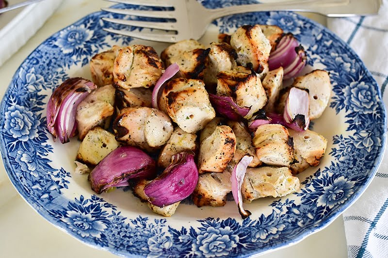 Grilled marinated chicken kebabs on a vintage blue platter, from Maureen Abood.