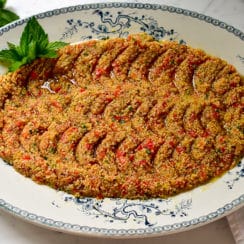 Tomato kibbeh on a blue and white platter with mint and olive oil, Maureen Abood