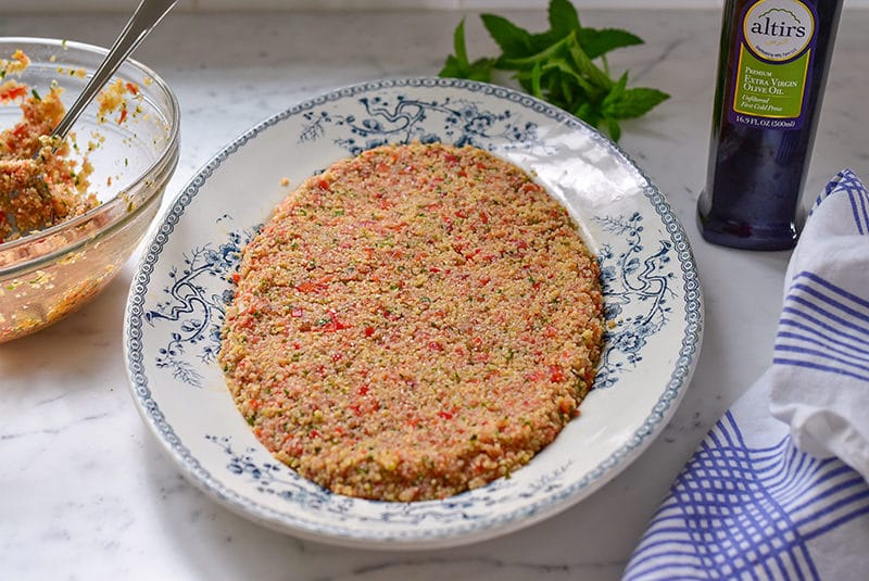 Tomato kibbeh on a platter with olive oil and mint, Maureen Abood
