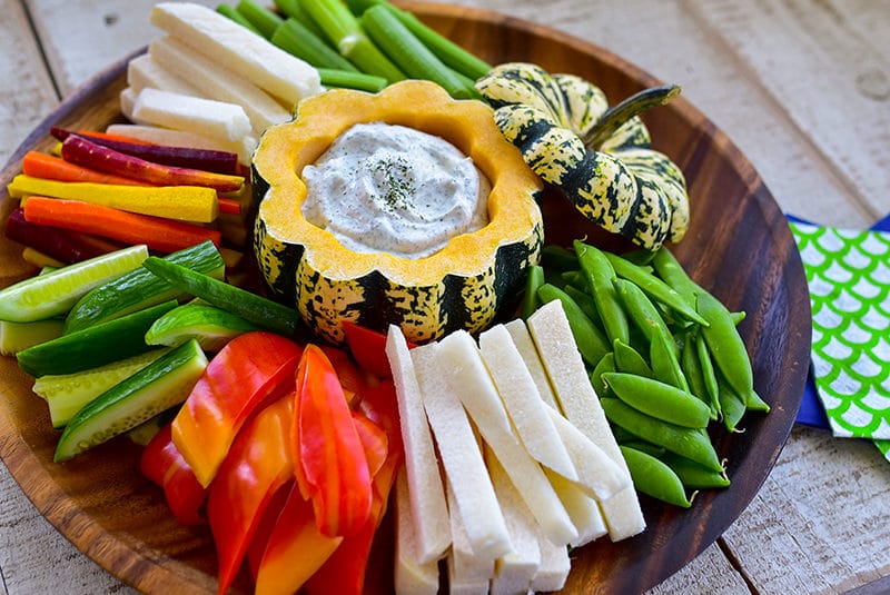 Labneh dip in a squash bowl with vegetables