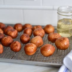 Lebanese donuts on a rack with syrup glaze