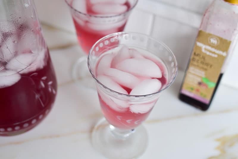 Lebanese Mulberry Syrup spritzer over ice in a beautiful glass, by Maureen Abood
