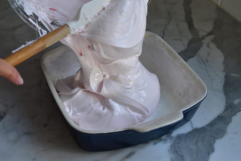 Pink marshmallow scraped from bowl to pan