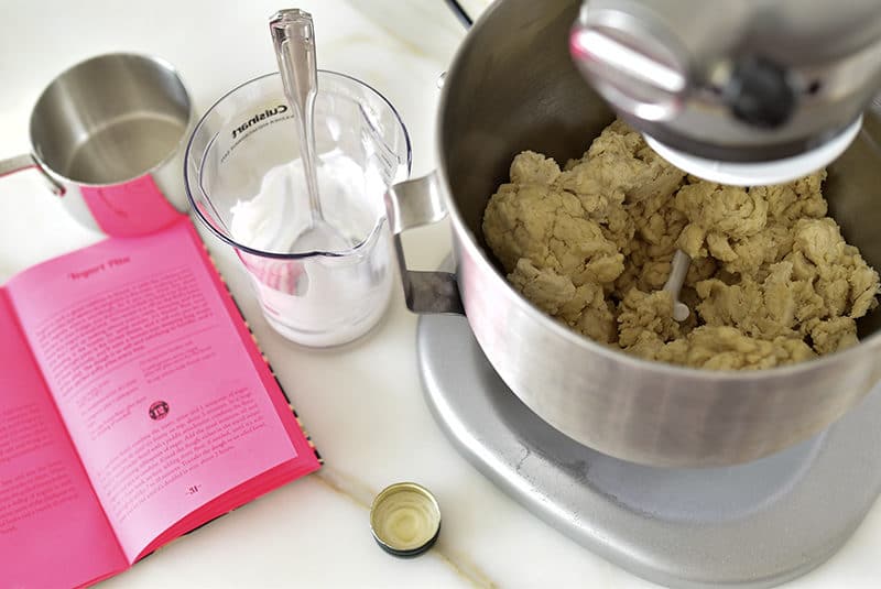 Yogurt with dough in the mixer for pita bread