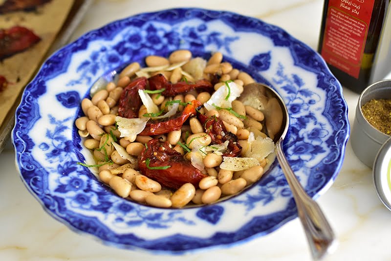 White beans with za'atar roasted tomatoes and olive oil, in a vintage blue pasta bowl
