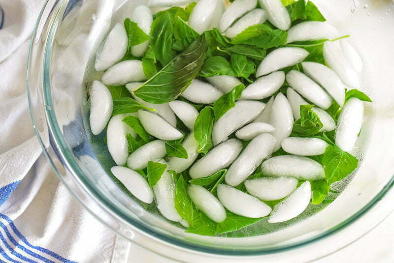 Basil in an ice bath in a glass bowl