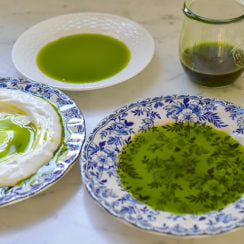 Basil oil in three plates on the counter