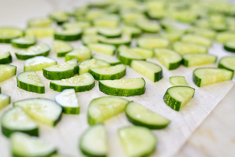 Slices of cucumber in a single layer on a paper towel
