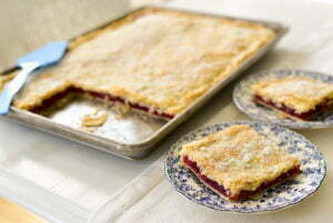 Slices of cherry slab pie pon blue and white plates