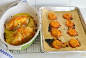 Apricot chicken in a roasting pan with roasted apricots
