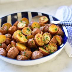 Roasted New Potatoes in a blue striped bowl on the counter