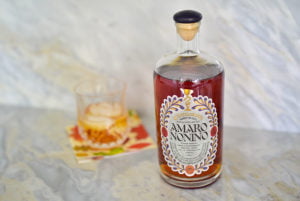 Amaro cocktail on the bar with Amaro Nonno bottle