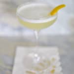 Gin Fizz cocktail in a coupe with lemon twist