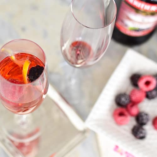 Kir Royale with frozen berries