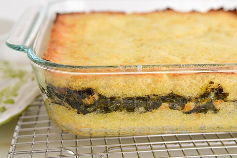 Potatoes layered with spinach in a glass dish