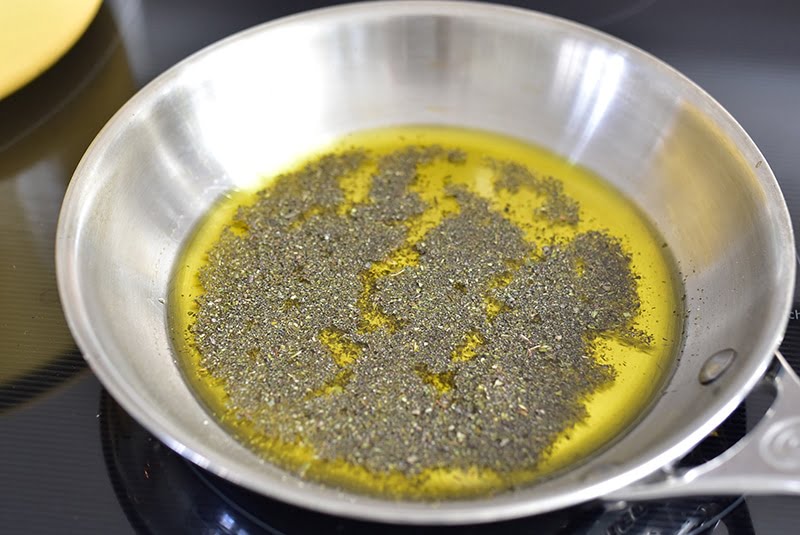 Dried mint in olive oil on the stove