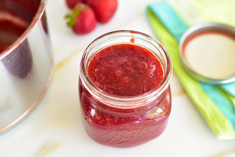Strawberry jam jar with berries