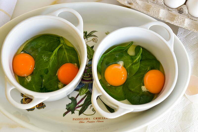 Eggs layered over spinach in ramekin coquettes