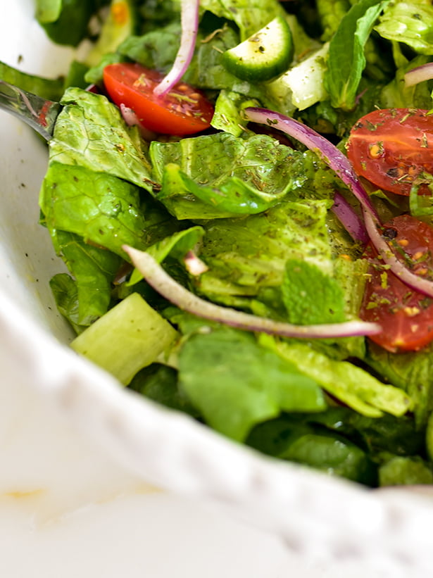 Romaine, tomatoes and onion and mint in a bowl for salad